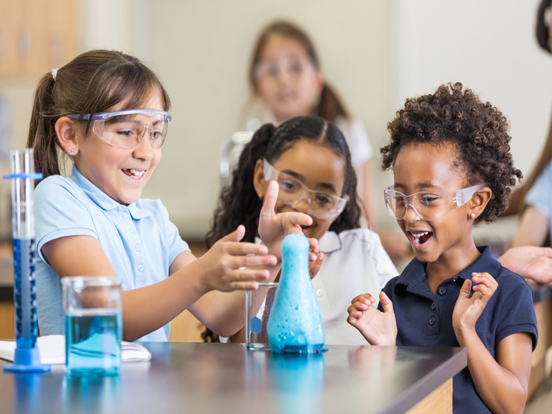 Kids in a classroom doing a science experiment