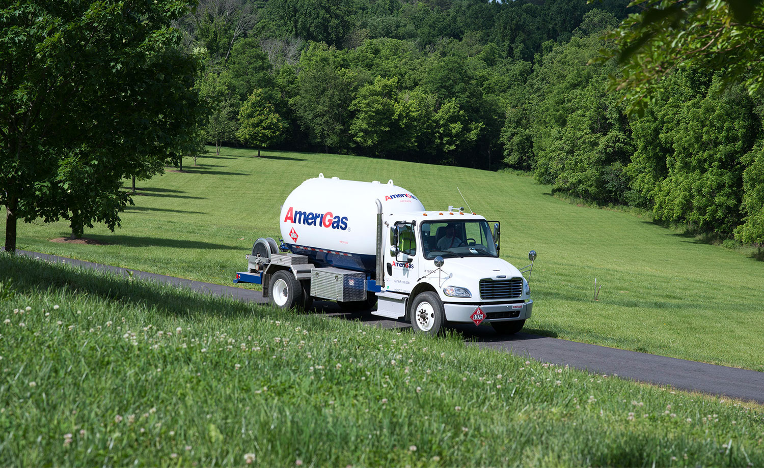 AmeriGas tanker truck on a lush rural road.