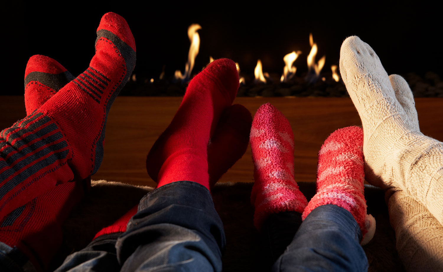 Feet in front of fireplace.